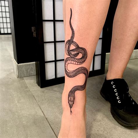 snake wrapped around leg tattoo|Snake tattoo leg